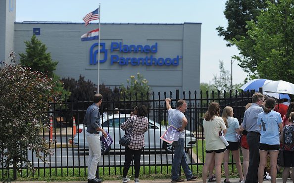 A group of demonstrators gather during a pro-life rally outside the Planned Parenthood Reproductive...
