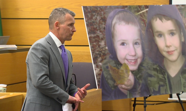 Attorney Ted Buck delivers opening statements to a jury while standing in front of a large photo pr...