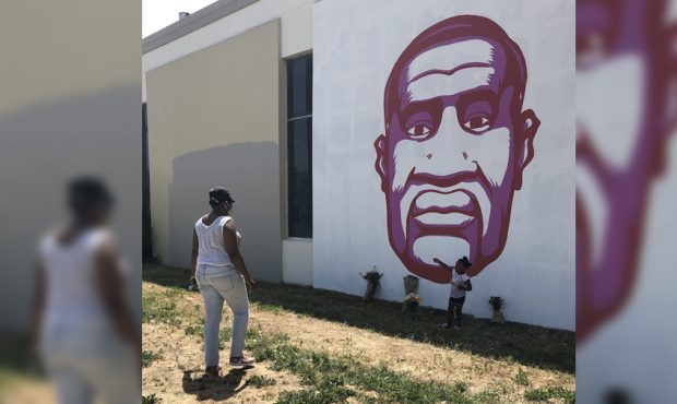 Ashley Cleveland and her 3-year-old daughter, Audrey, pay their respects at a Salt Lake City mural ...