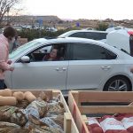 Volunteers help distribute food during a Farmers Feeding Utah event in St. George on Jan. 29, 2021. (Marc Weaver/KSL-TV)