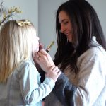 Emily McFarland helps her oldest daughter Charlotte put on a little bit of lip gloss. Emily says Charlotte feels most loved by physical affection and by talking.
