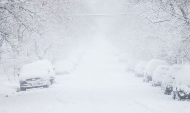 FILE -- Fog and blowing snow obscure a street. (Photo by Michael Ciaglo/Getty Images)...