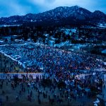 In this aerial view from drone, mourners gather at a candlelight vigil at Fairview High School on March 25, 2021 in Boulder, Colorado. Ten people, including a police officer, were killed in a shooting at a nearby King Soopers grocery store on Monday. (Photo by Michael Ciaglo/Getty Images)