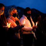 Mourners gather at a candlelight vigil at Fairview High School on March 25, 2021 in Boulder, Colorado. Ten people, including a police officer, were killed in a shooting at a nearby King Soopers grocery store on Monday. (Photo by Michael Ciaglo/Getty Images)