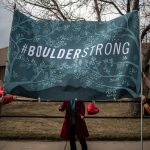 Organizers erect a #BoulderStrong banner before a vigil to commemorate the victims of a mass shooting at a King Soopers grocery store on Thursday, March 25, 2021 in Boulder, Colorado. The Monday shooting left ten people dead, including one police officer. (Photo by Chet Strange/Getty Images)