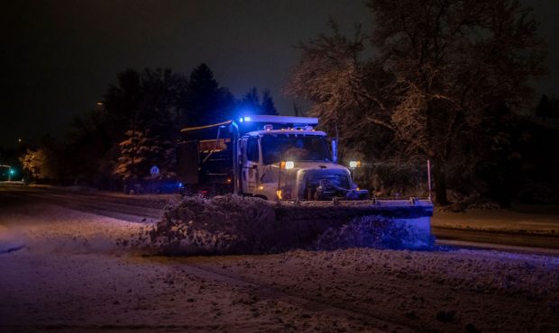 A snowplow clears streets of heavy snow during a winter storm in Boulder, Colorado, U.S., on Saturd...