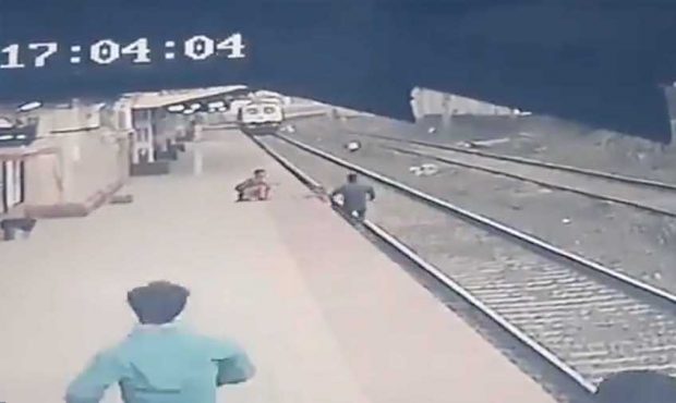 Footage released April 19 shows railroad worker Mayur Shelkhe lifting a child to safety as a train ...