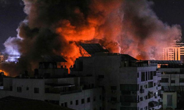 Fire and smoke rise above buildings in Gaza City as Israeli warplanes target a governmental buildin...