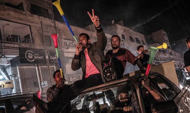 Palestinians celebrate the cease-fire agreement between Israel and Hamas on May 21, 2021 in Gaza Ci...