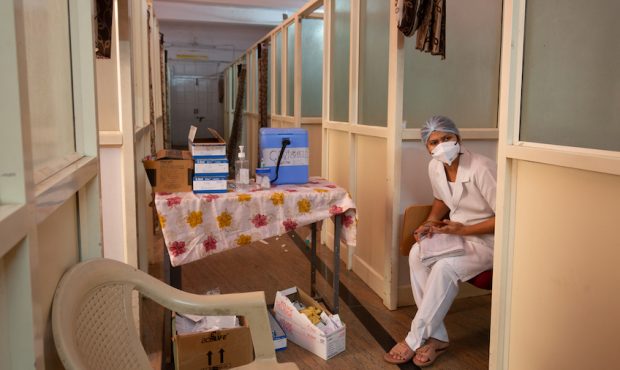A nurse waits for people to be inoculated with AstraZeneca-Oxford's Covishield vaccine against COVI...