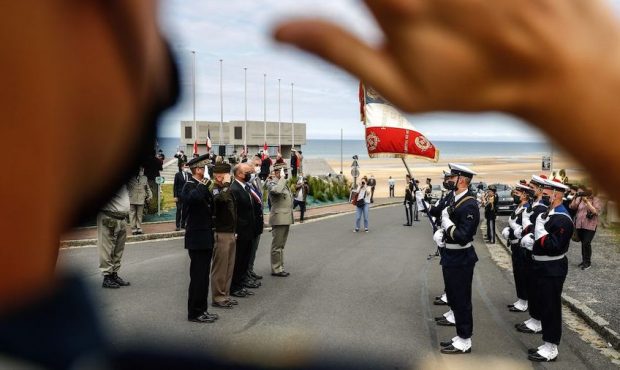 Officials and military officers salute the French armored naval infantry 'Regiment Blinde de Fusili...