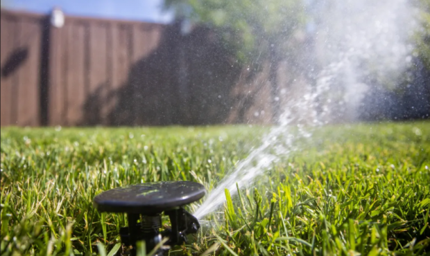 Sprinklers water a lawn in Salt Lake City on Friday, May 7, 2021. Utah Gov. Spencer Cox issues his ...