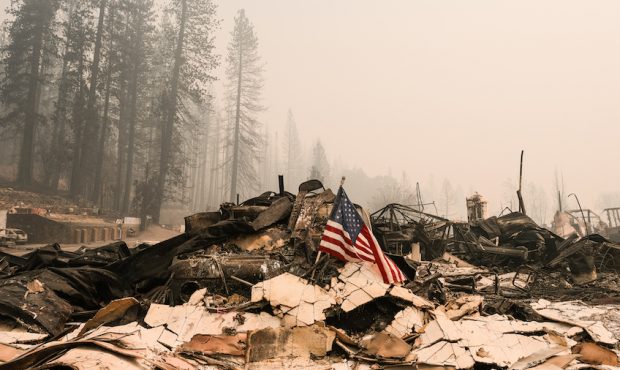 An American flag rests on rubble of the Greenville Fire Department  destroyed by the Dixie Fire on ...