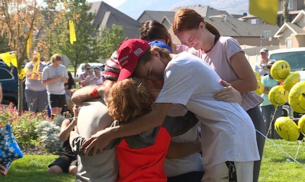The Greene family embraces their father after he returned home from the hospital, following a two m...