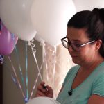 Summer Smart writes notes to her late son, Jordan Mair, on balloons before releasing them on his first heavenly birthday, July 26. (Josh Szymanik/KSL TV)