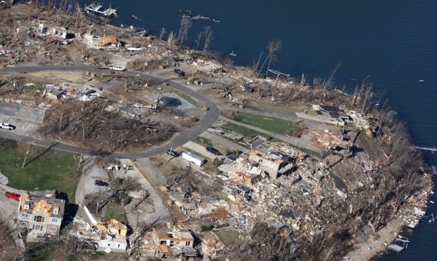 In this aerial view, homes and surrounding area are heavily damaged after they were hit by a tornad...