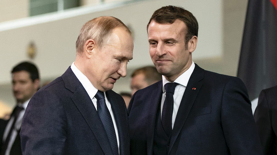 FILE: French President Emmanuel Macron (R) and Russian President Vladimir Putin (L) arrive for a fa...