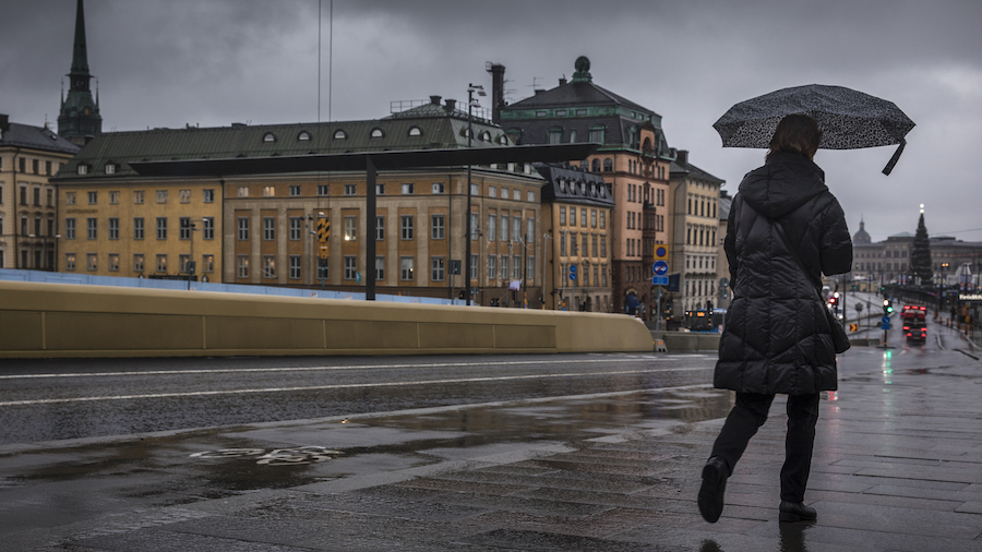 FILE: A female pedestrian crosses over a bridge at Slussen. After COVID-19 outbreak in Stockholm, m...