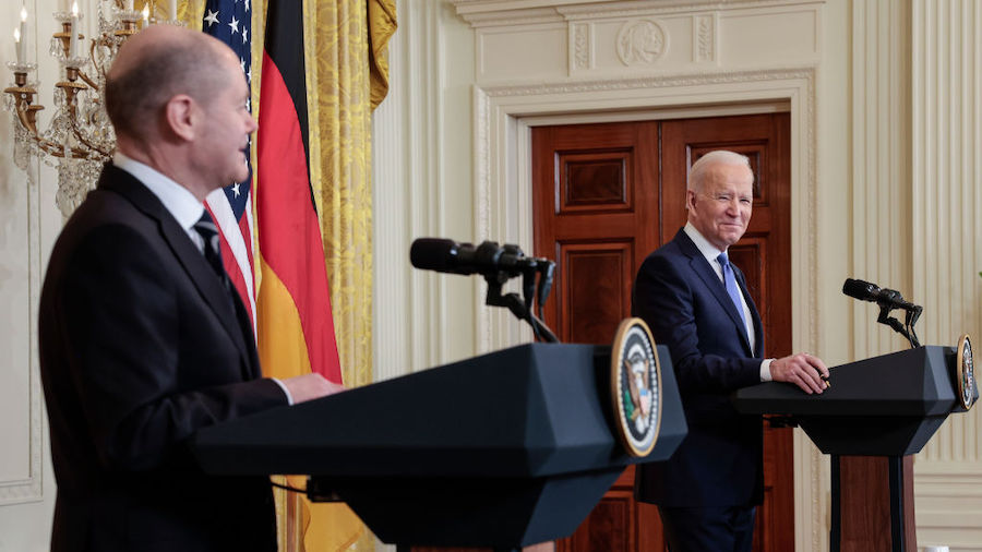 U.S. President Joe Biden (R) reacts as German Chancellor Olaf Scholz delivers remarks during a join...