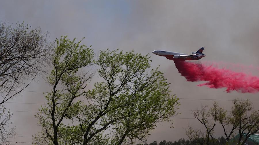 A Very Large Air Tanker makes a drop on a ridge west of Las Vegas, New Mexico. Retardant was used t...
