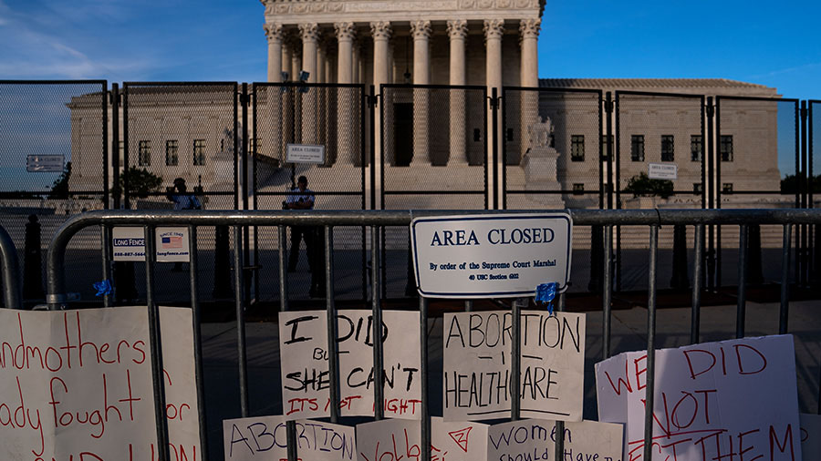 Signs left by abortion-rights supporters line the security fence surrounding The Supreme Court on J...