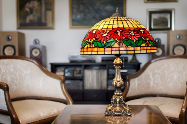 stained glass lamp with red flowers featured in a living room setting