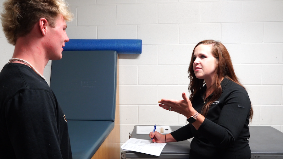 Dynna Farr, athletic trainer at Intermountain Healthcare for Wasatch High School, talks with 17-yea...