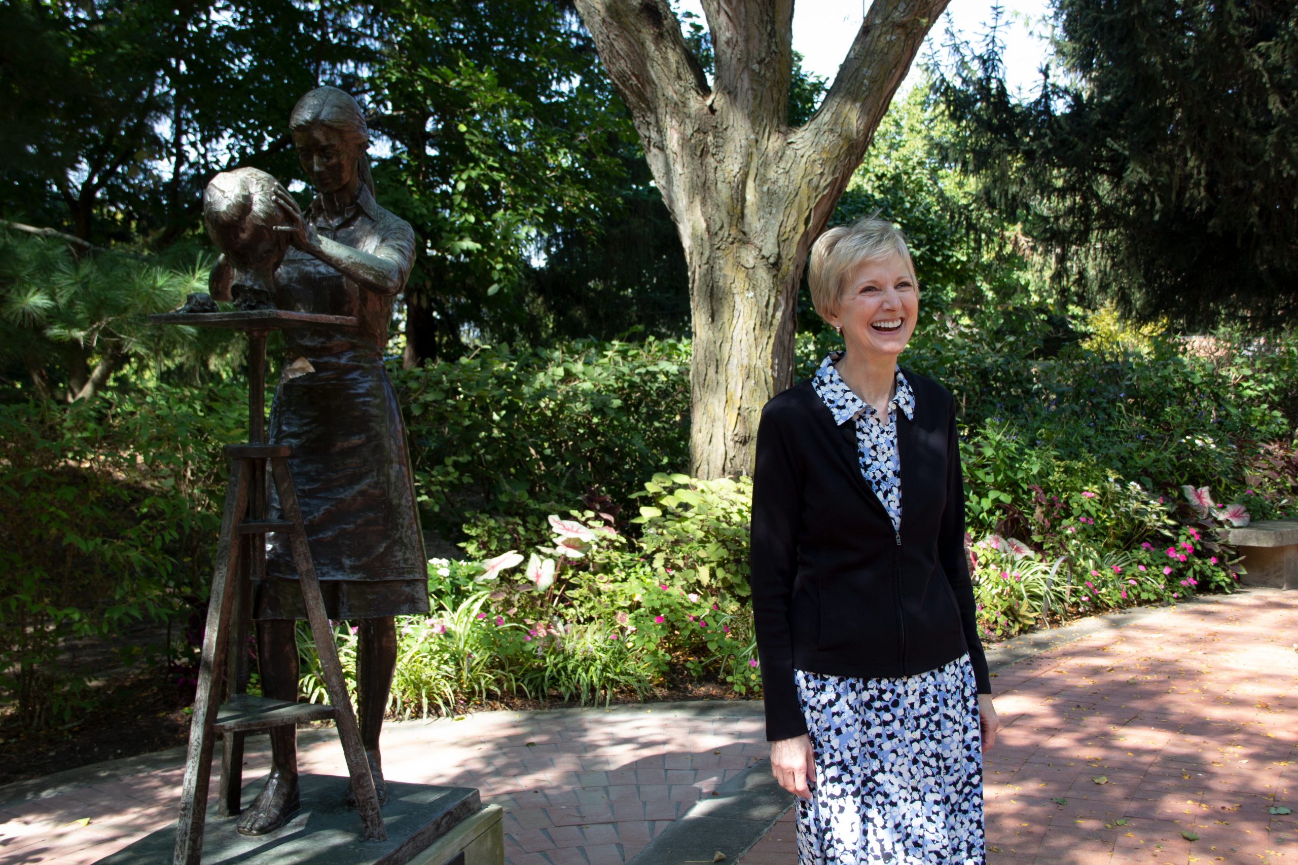 Relief Society General President Jean B. Bingham smiles in the Monument to Women garden in historic...