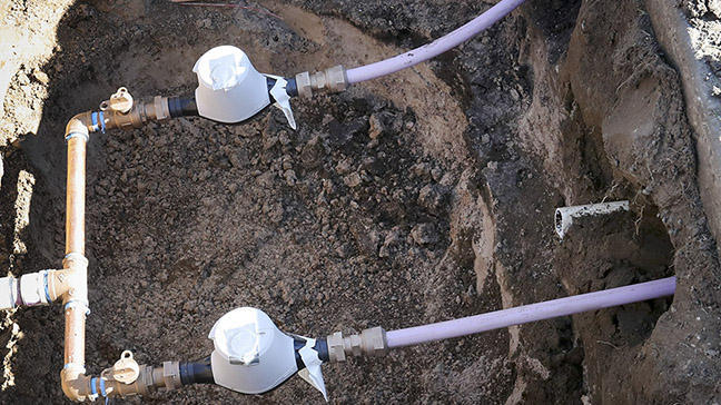 Ormond Construction crews install secondary water meters in a subdivision in Woods Cross for the We...