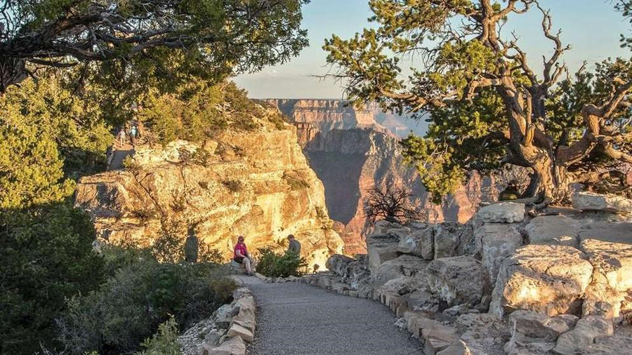 Hikers relax at the Bright Angel Point Trail on the north rim of the Grand Canyon. (National Park S...