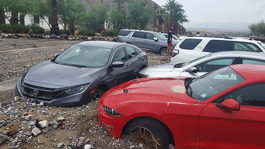 Cars are seen stuck in mud and debris at The Inn at Death Valley on August 5. (National Park Servic...