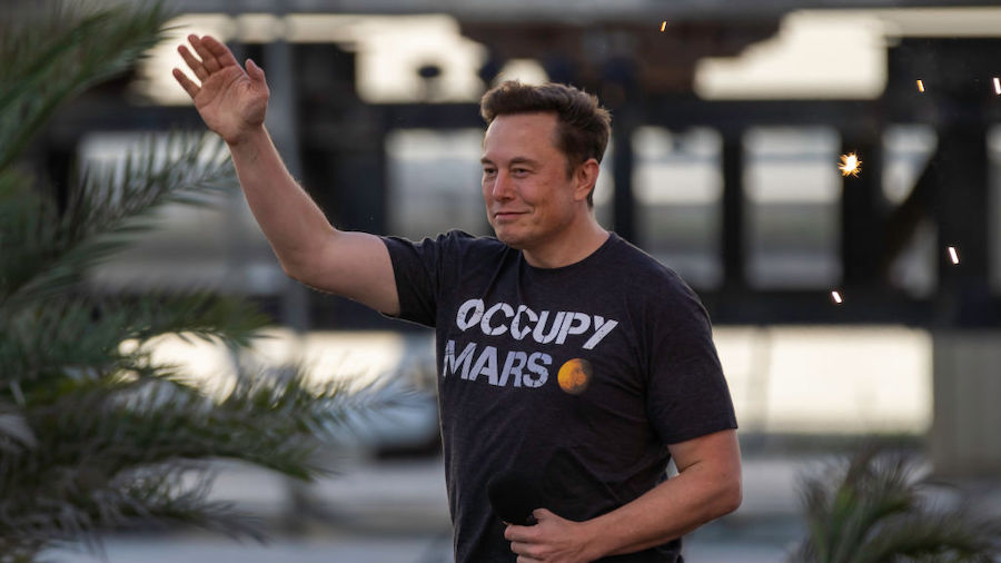 SpaceX founder Elon Musk walks on stage during a T-Mobile and SpaceX joint event on August 25, 2022...