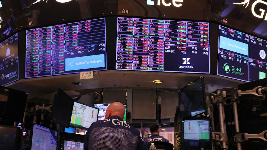 Traders work on the floor of the New York Stock Exchange during afternoon trading on August 22, 202...