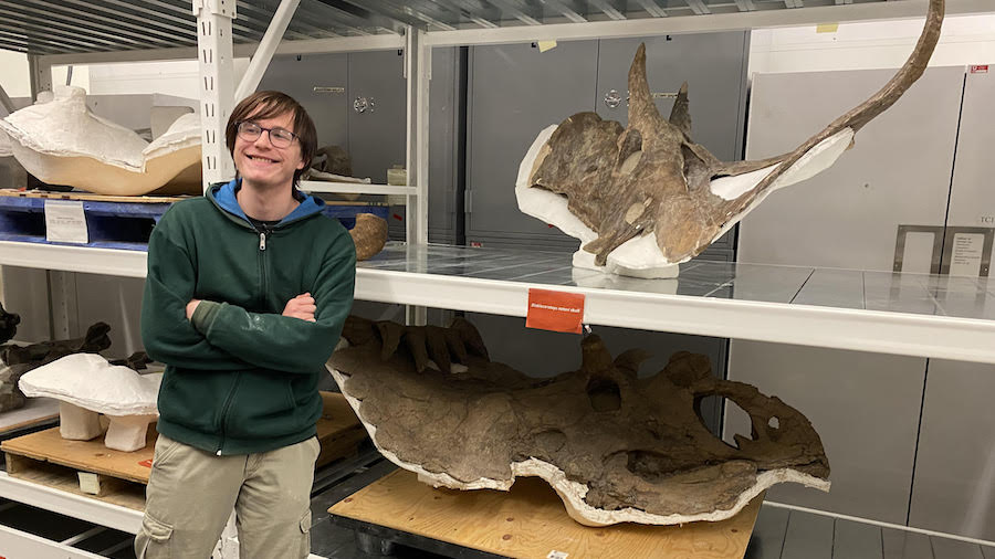 Kaleb, 19, poses for a picture with the famous Kosmoceratops at the Natural History Museum of Utah....