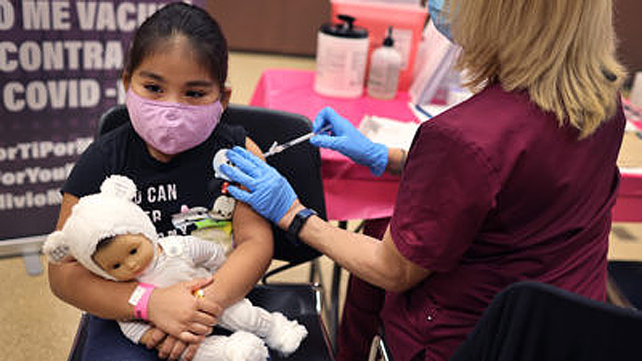 First grade student, seven-year-old Rihanna Chihuaque, receives a covid-19 vaccine.   (Photo by Sco...