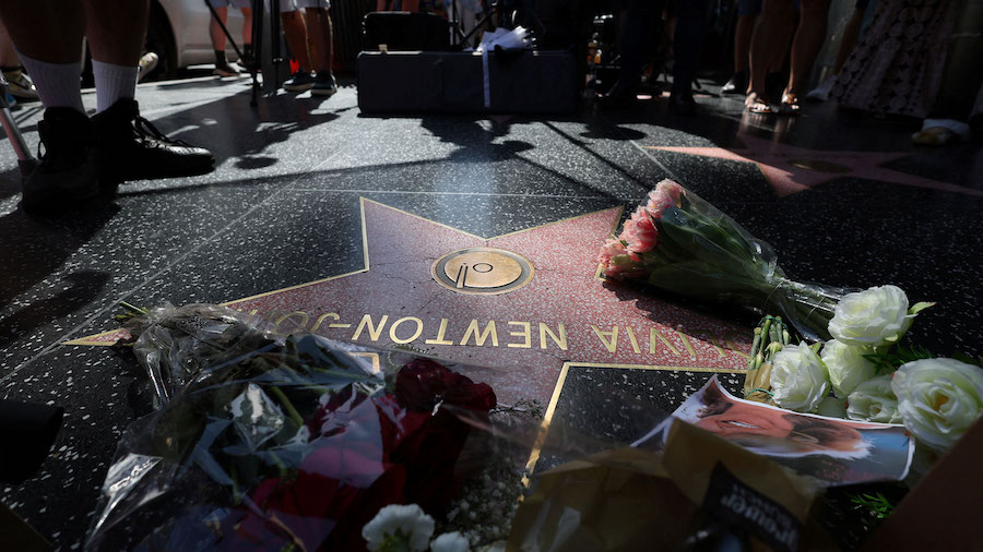 The star of late actor Olivia Newton-John is adorned with flowers and photographs on the Hollywood ...