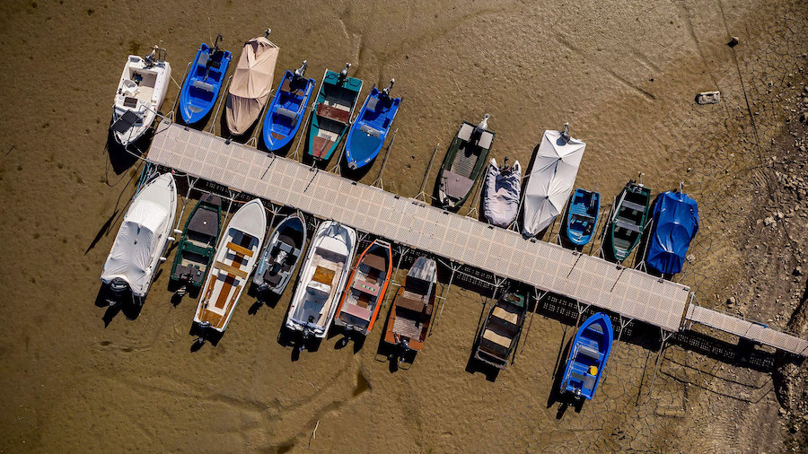 Boats sit on the dry bed of Brenets Lake on the border of France and Switzerland on July 18. (Fabri...