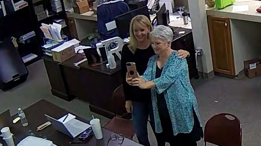 In this Jan. 7, 2021, image taken from Coffee County, Ga., security video, Cathy Latham (right) app...
