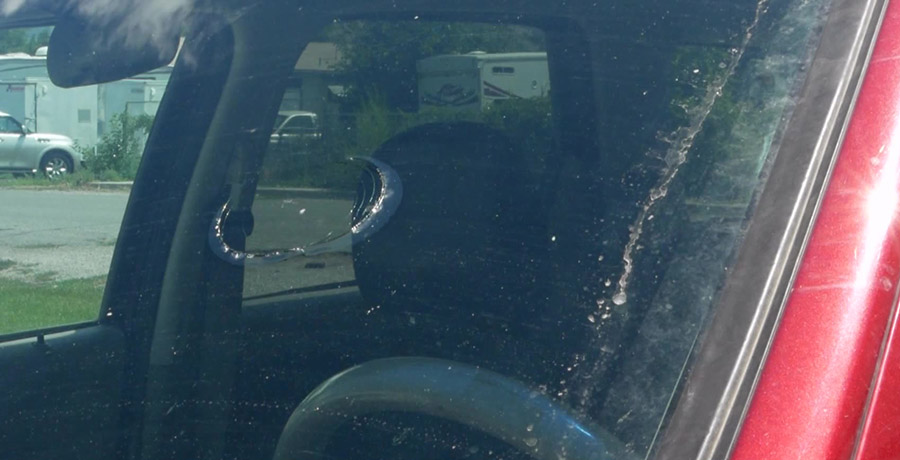 The smashed windshield after debris hit it....