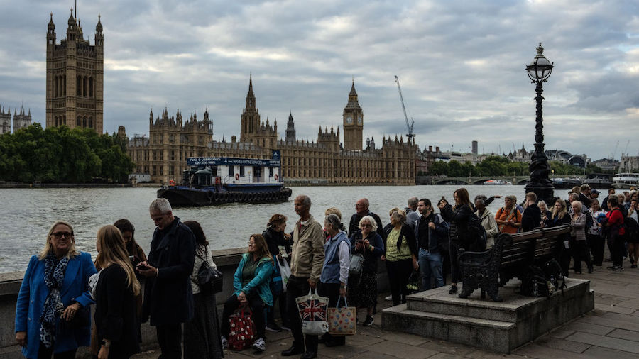 People queue to visit the Palace of Westminster where the body of Queen Elizabeth II is lying in st...