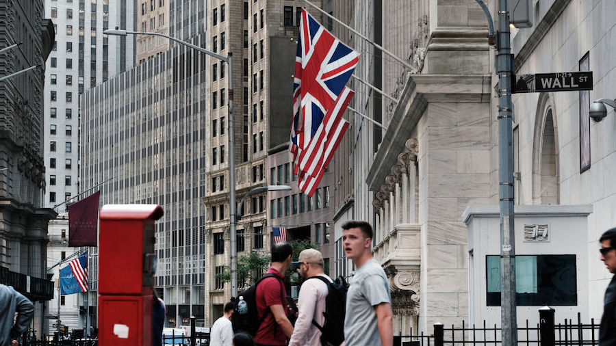 People walk by the New York Stock Exchange (NYSE) on September 16, 2022 in New York City. The Dow J...