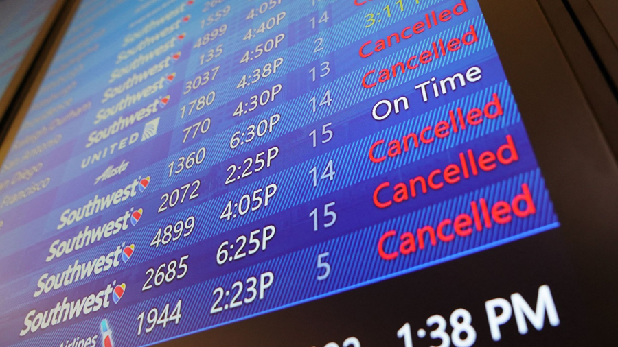 The arrival and departures board lists numerous flight cancelations at Tampa International Airport ...