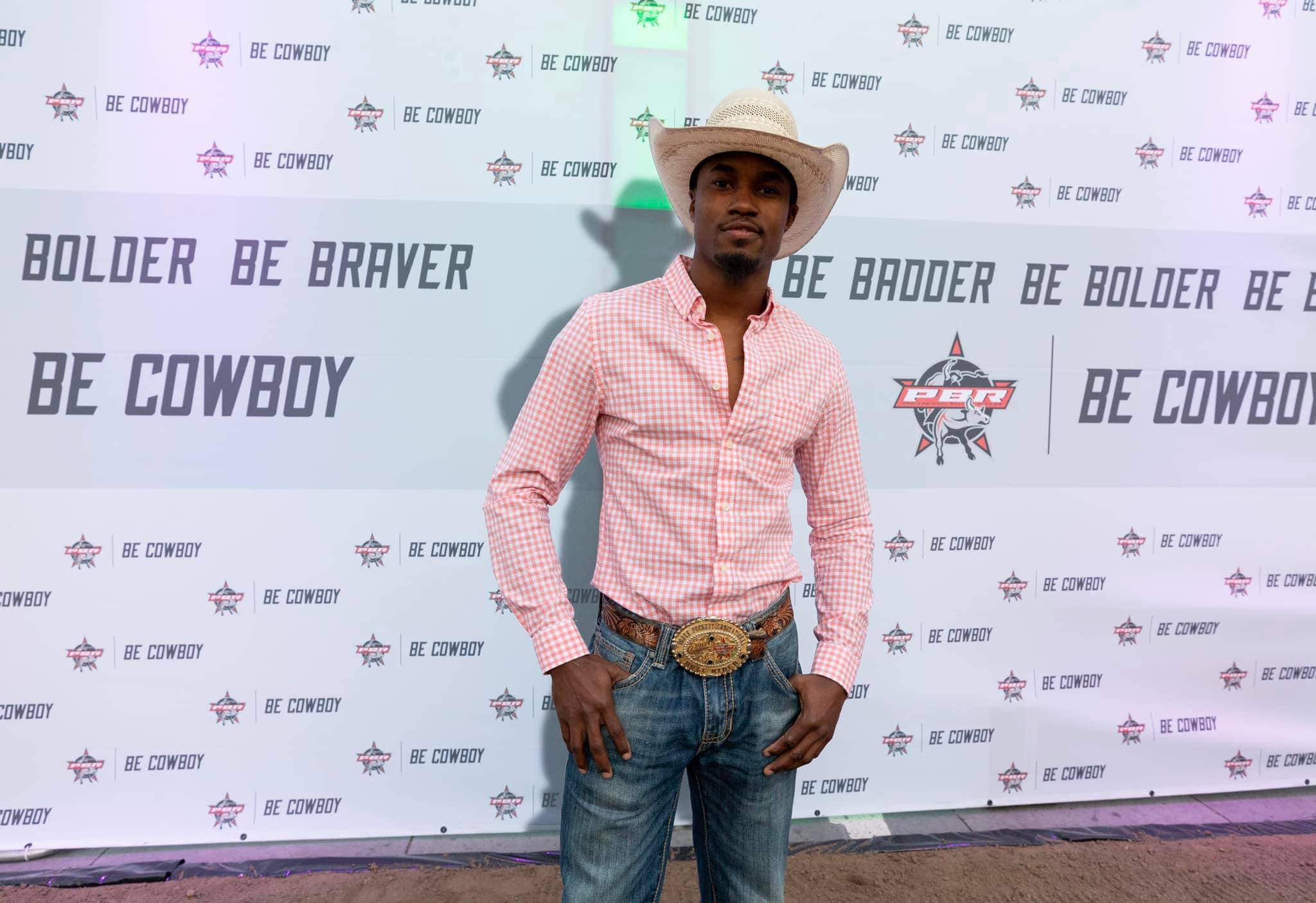Allen is seen in rodeo gear with a professional backdrop...