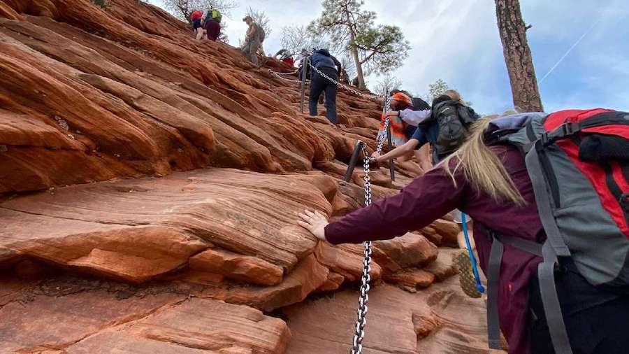 Hikers climb up the chained section of the hike to Angels Landing at Zion National Park on March 26...