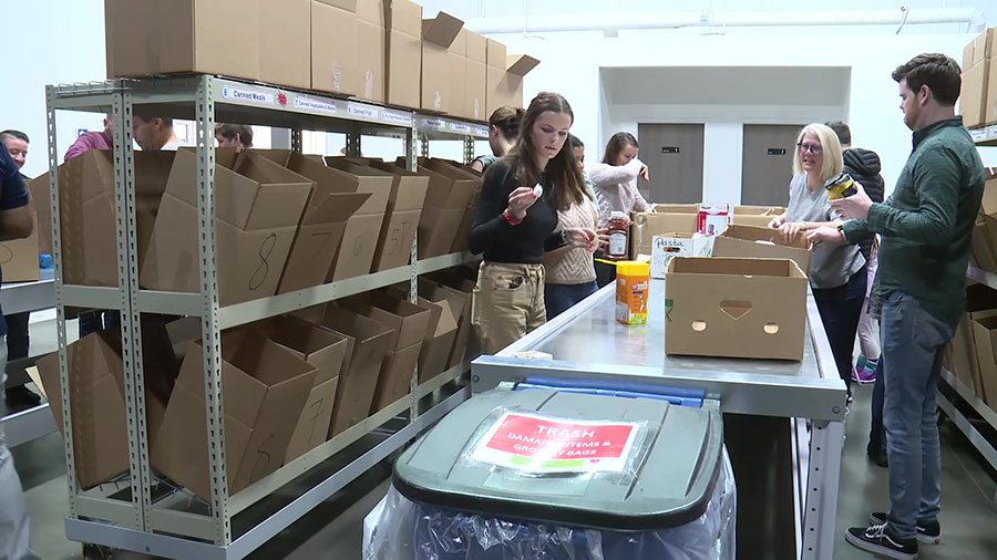 Salt Lake City officials, first responders, and volunteers sorting goods for the Utah Food Bank. (K...