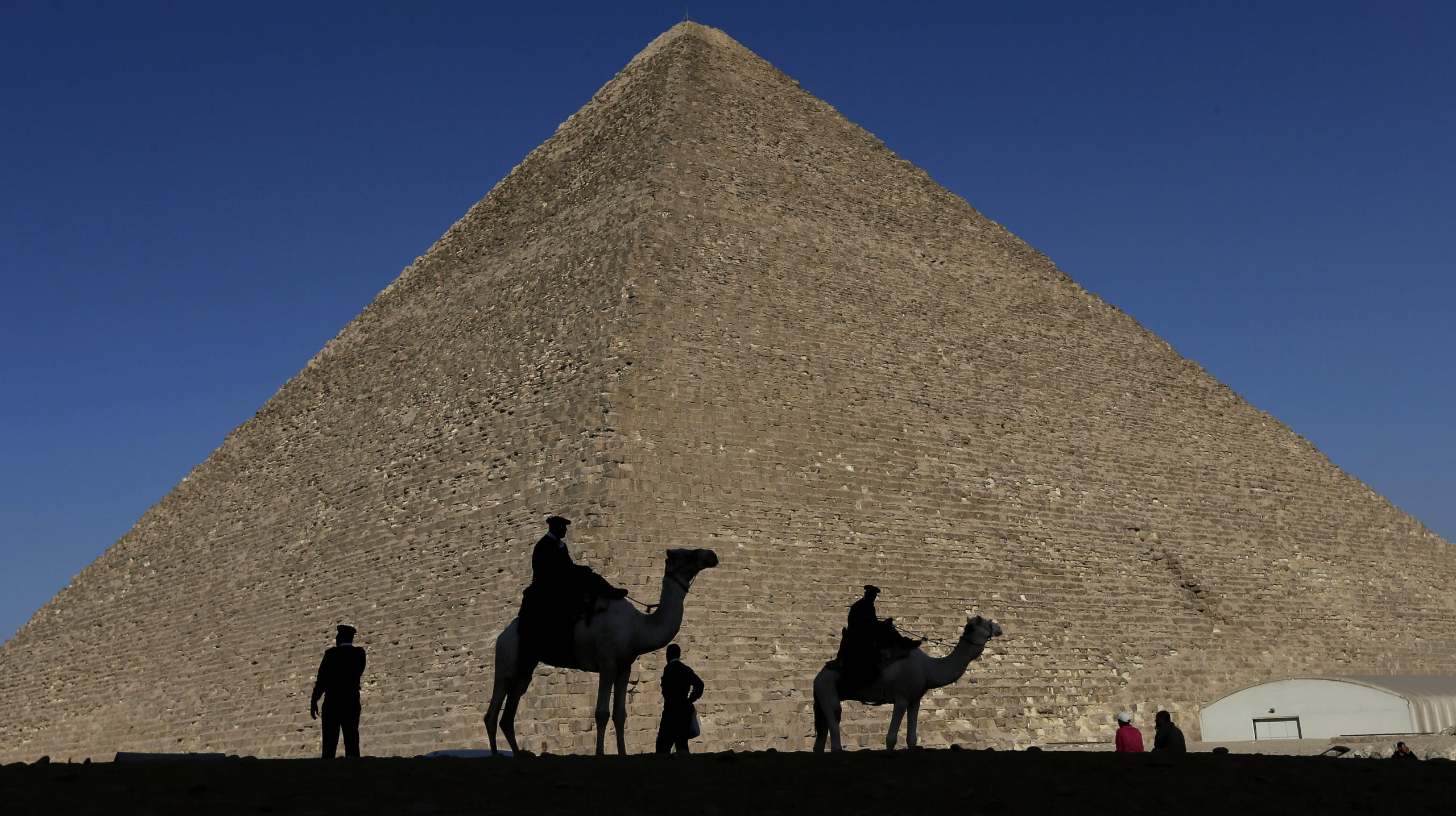 FILE - Policemen are silhouetted against the Great Pyramid in Giza, Egypt, Dec 12, 2012. Egypt unve...