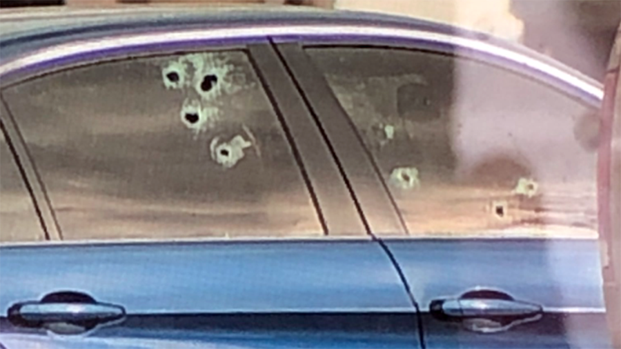 window with bullet holes...