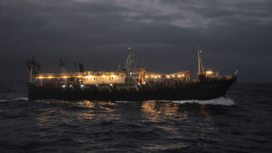 A ship fishing for squid on the high seas near the Galapagos Islands. (Joshua Goodman/AP)...