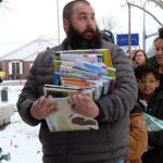 The entire Regan family showed up to help the Spanish Fork community fill the new library with books. (Mark Less/KSL TV)