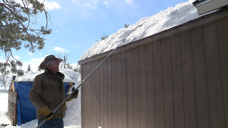 FILE: JR Johansen clearing off the snow from his roof. (KSLTV/Stuart Johnson)...